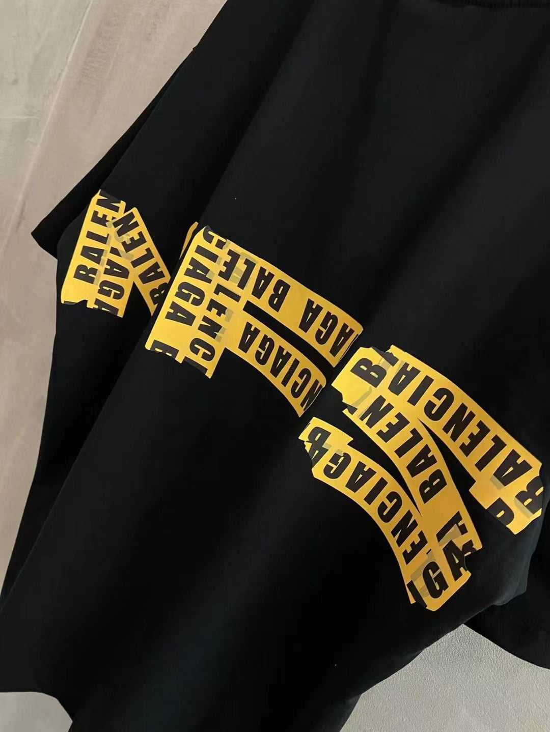 Black short-sleeve T-shirt sleeve with yellow “Need for speed” text print.