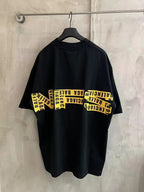 Black short-sleeve T-shirt with yellow “Need for speed” text graphic across chest.