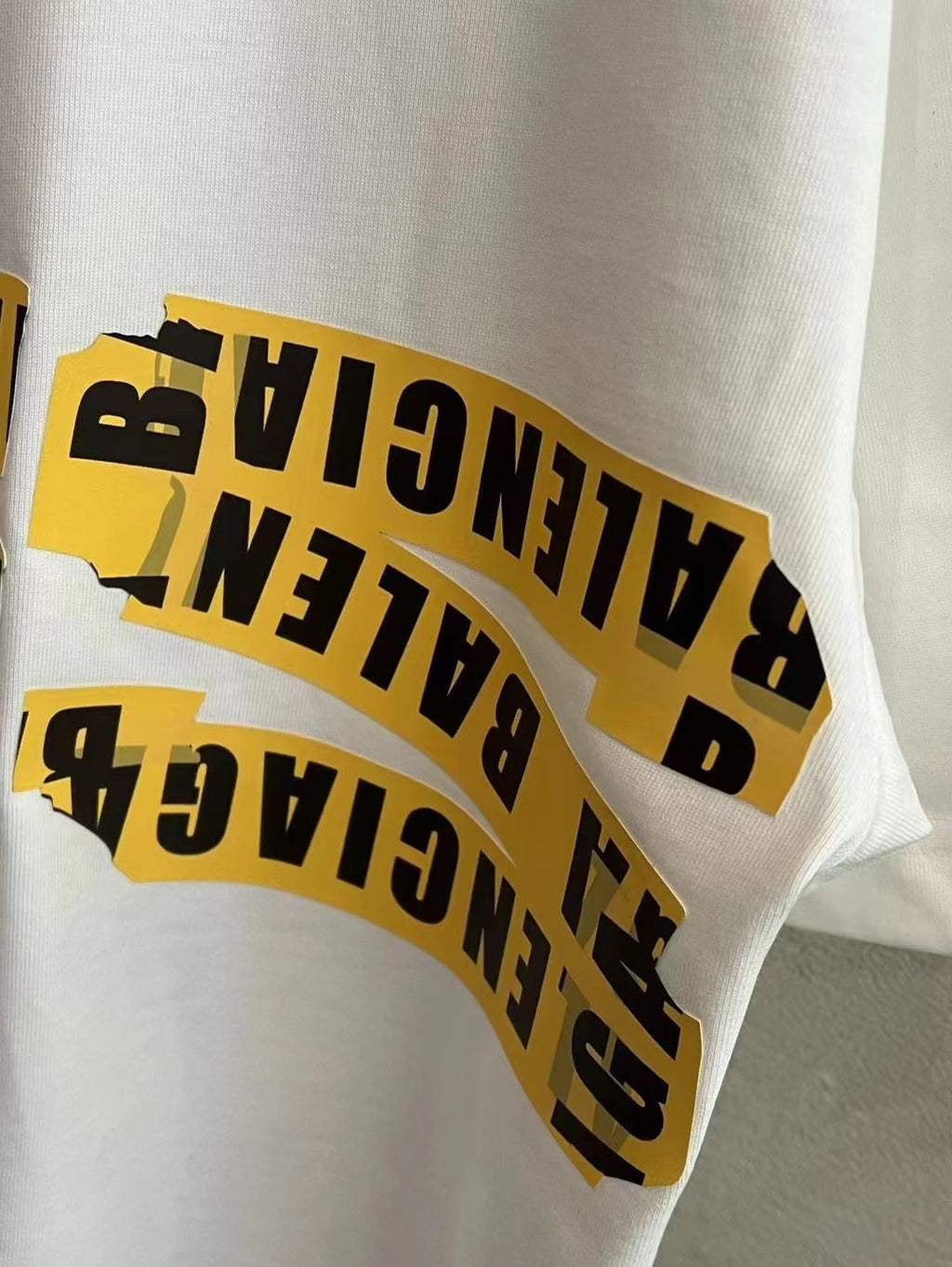 Balenciaga sleeve print with yellow and black lettering on white short-sleeve T-shirt