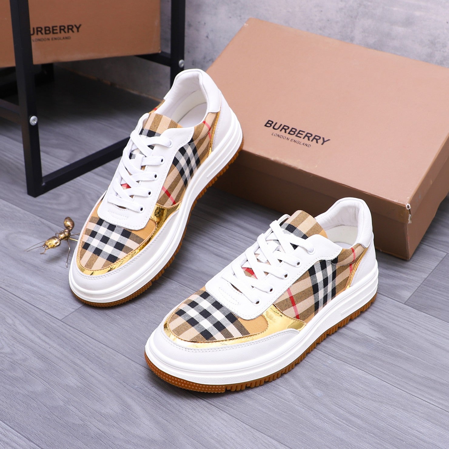 White Burberry sneakers with check panel uppers and orange rubber sole