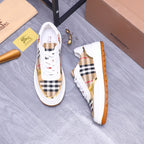 Pair of white Burberry sneakers with check uppers and orange textured side sole