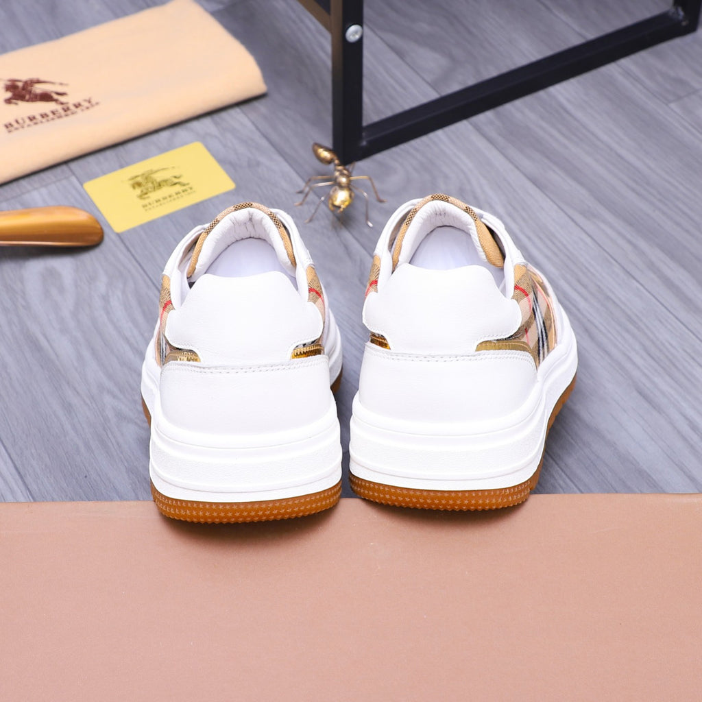 Back view of two white Burberry sneakers with check accents and orange soles