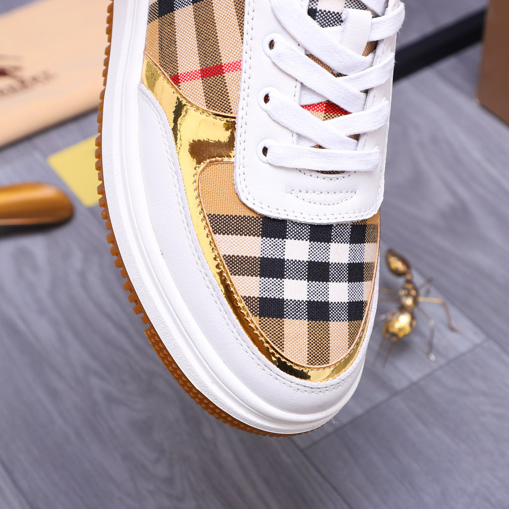 Close-up of white Burberry sneaker with check panel upper and gold side accent