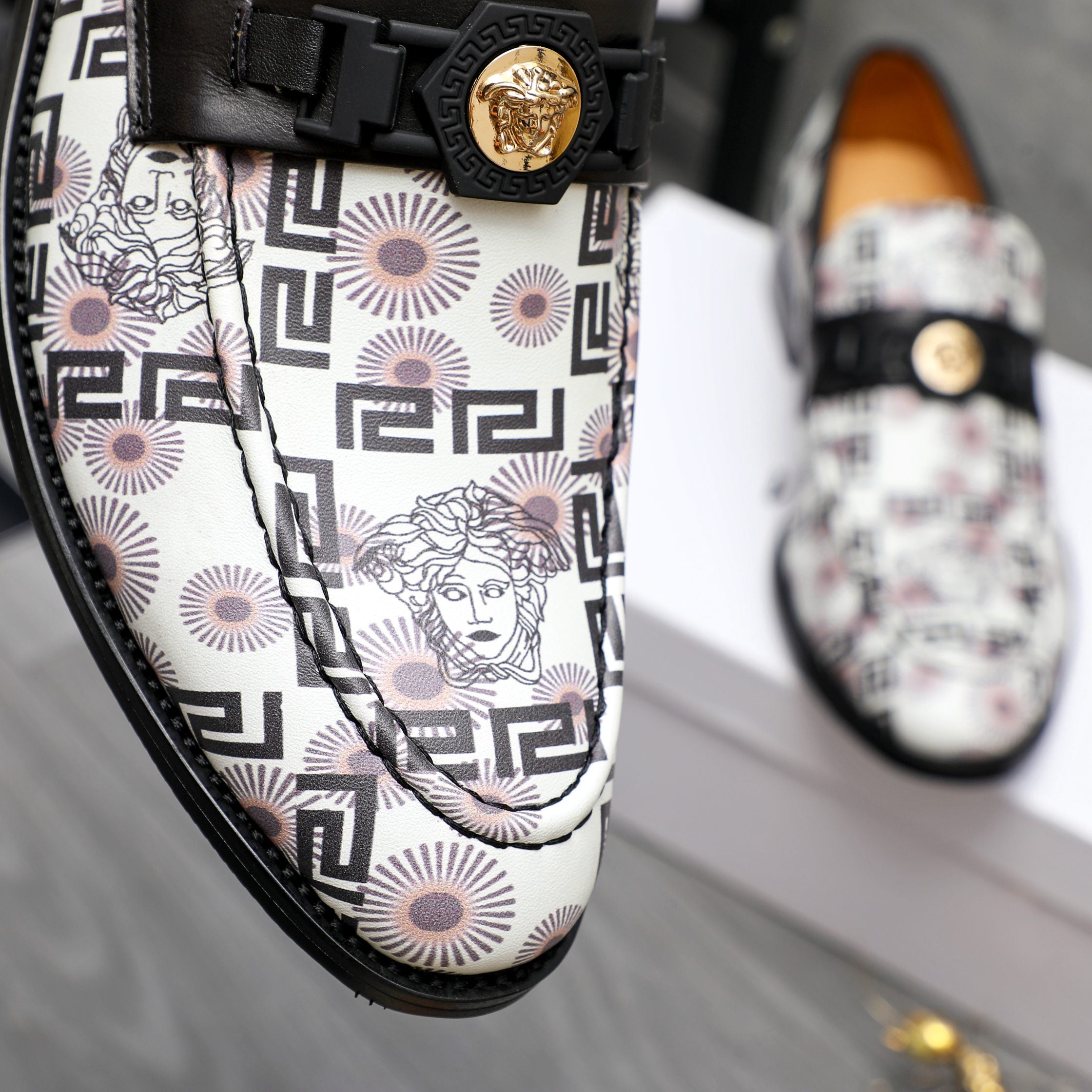 Versace loafer upper with black strap, gold medallion buckle, geometric Medusa print.