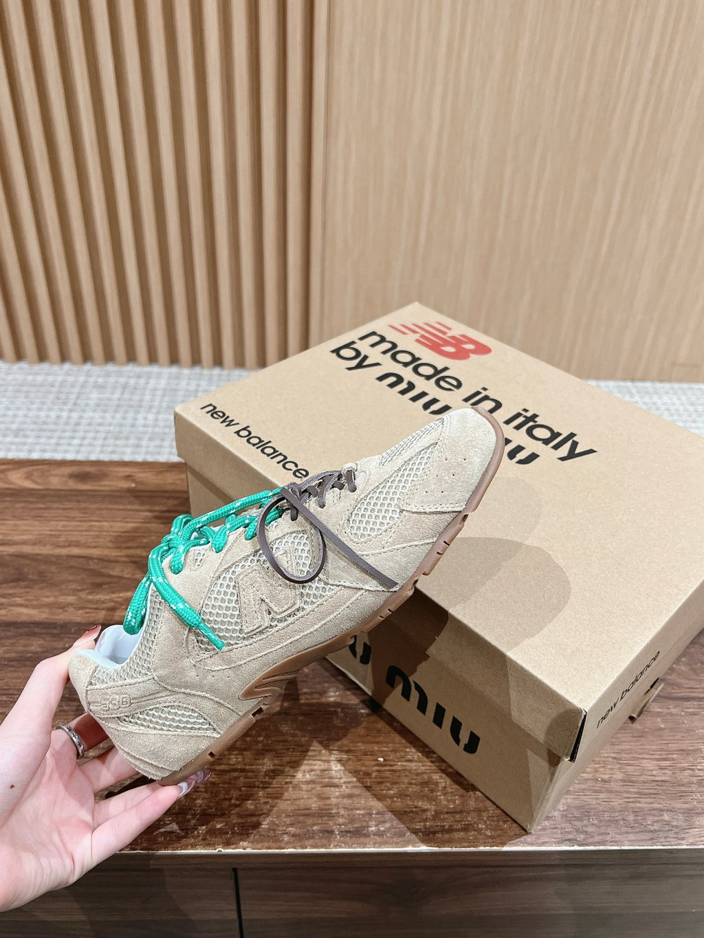 Prada unisex sneakers with beige uppers, teal laces, and white outsole trim