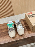 Prada unisex sneakers, beige uppers with teal-and-brown laces and white lace pair