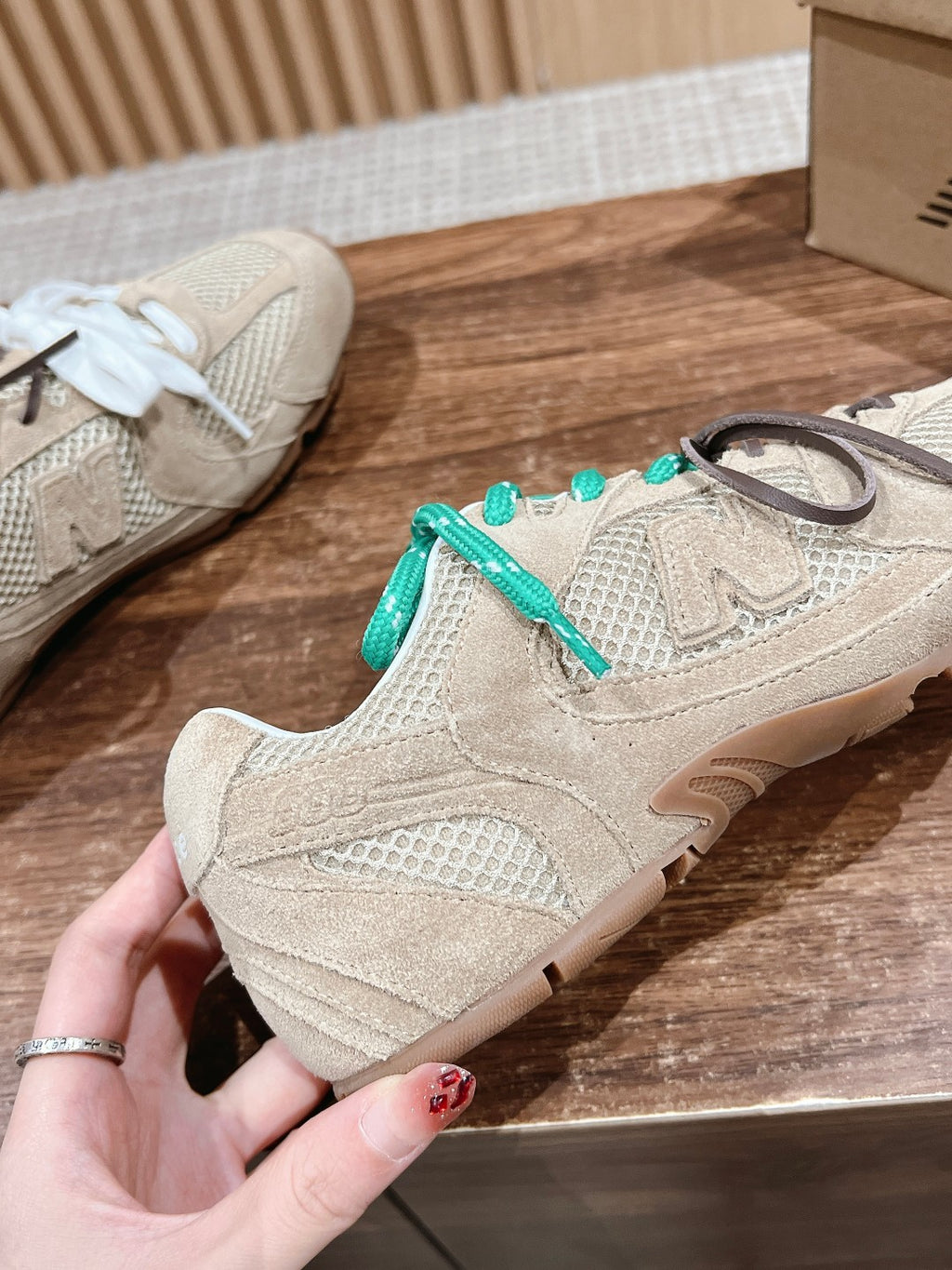 Prada unisex sneakers, beige suede-look uppers with teal laces and white lace shoe shown