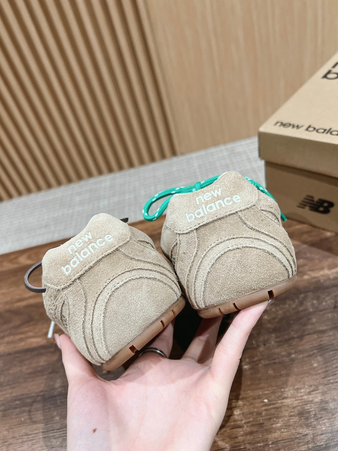 Prada unisex sneakers pair, beige with teal lace accents, heel logos visible