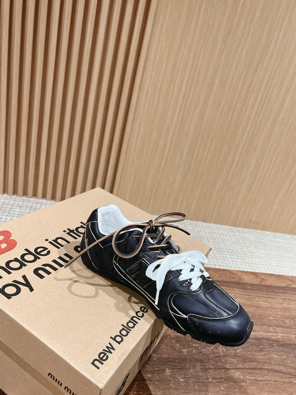 Black unisex sneakers with white laces and lace-up front