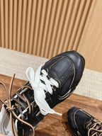 Black unisex low-top sneakers with white laces, side view