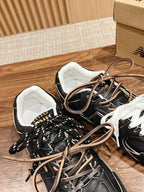 Black unisex sneakers with mixed lace colors, close-up of uppers