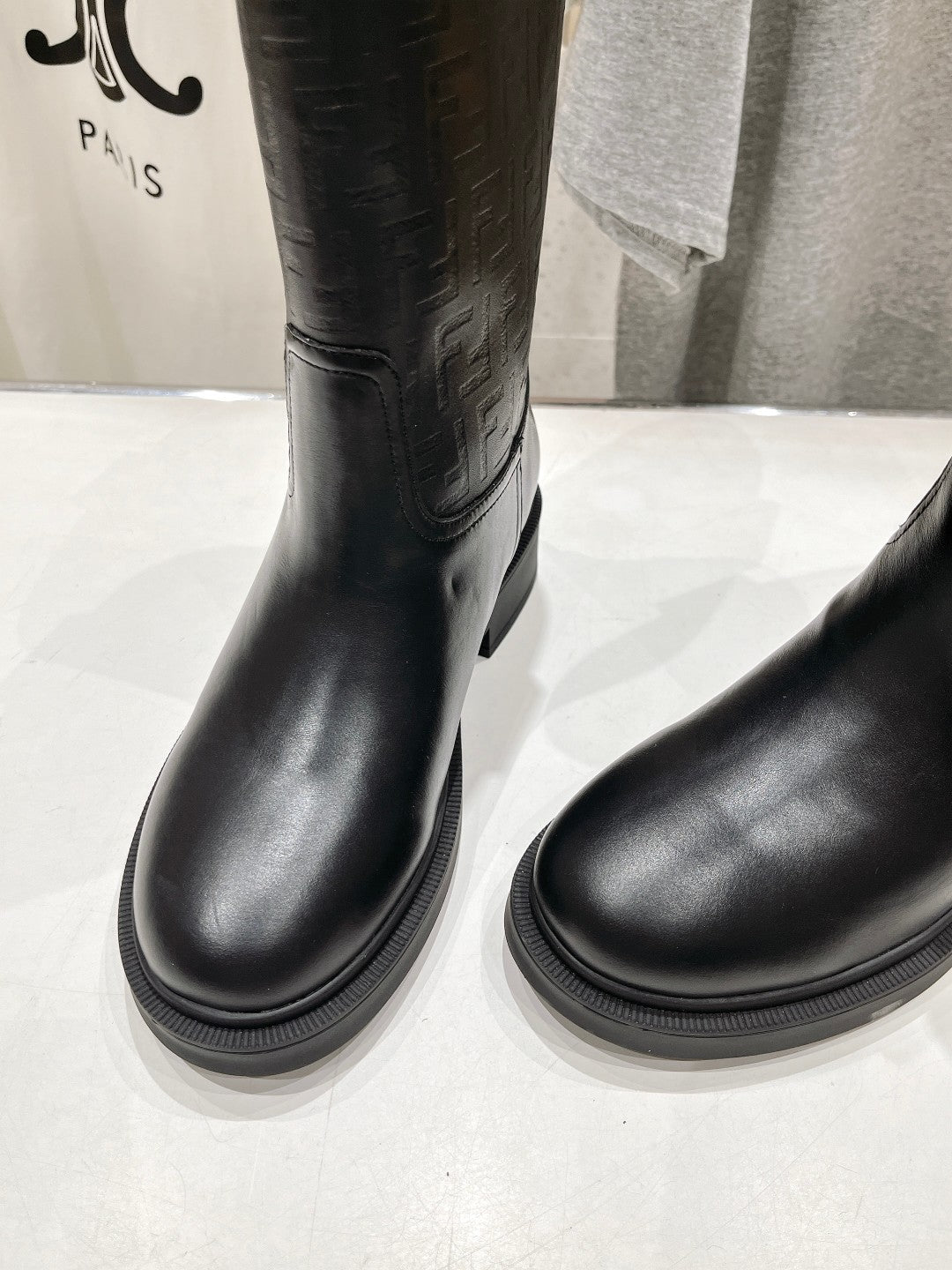 Black mid-calf pull-on boots with smooth rounded toe and thick sole