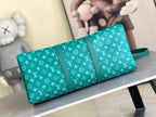 Teal monogram duffel bag with rolled top handles and long front strap