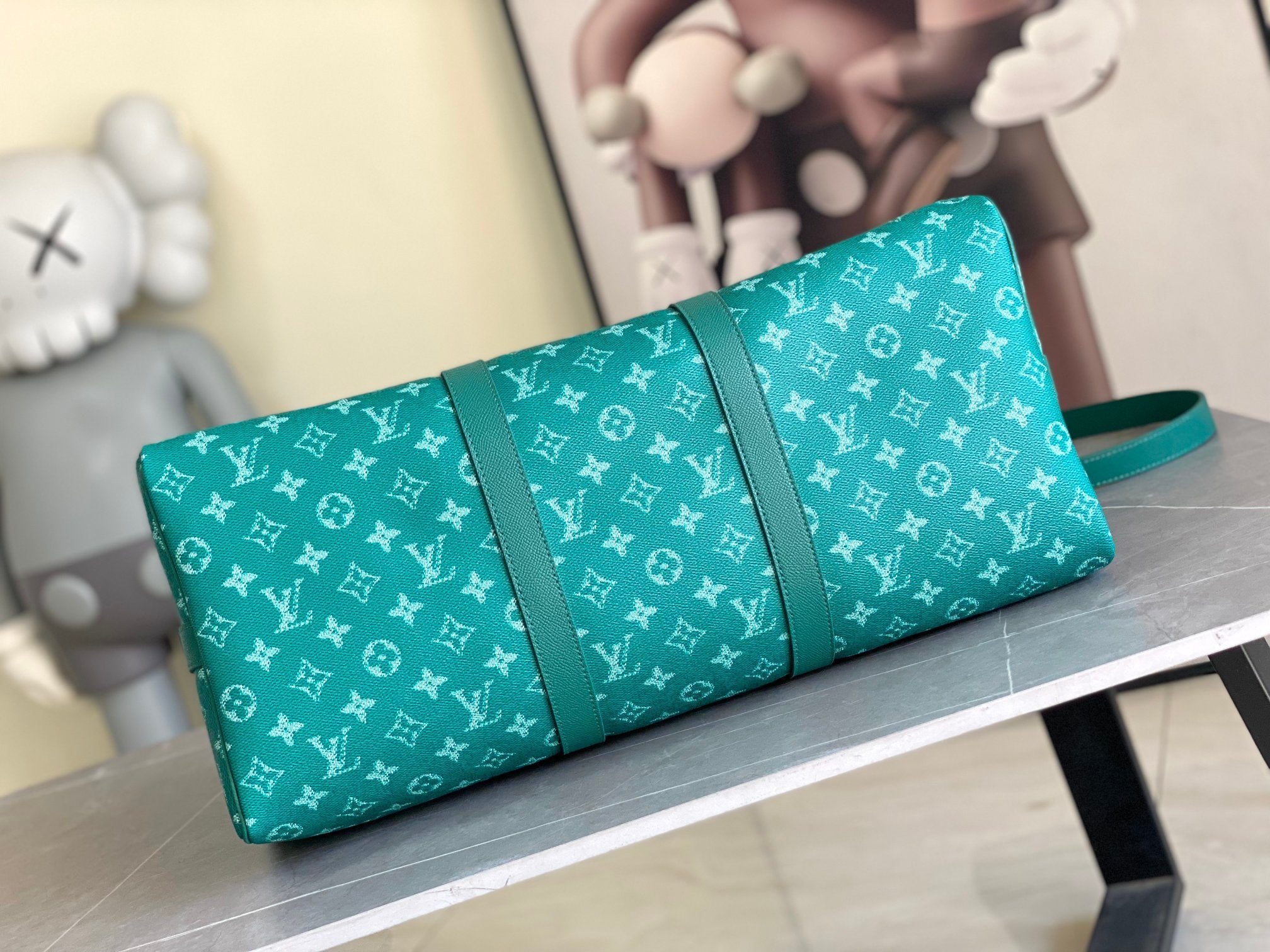 Teal monogram handbag with wide center panel and short handle
