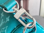 Teal pebbled leather bag with silver-toned clasp, key ring, and strap loop