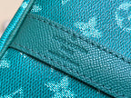 Teal pebbled leather panel with stitched edge and embossed monogram pattern