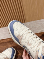 Dior unisex sneaker close-up, beige leather toe with perforations and blue collar.