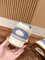 Dior unisex sneakers, back view with blue heel panel and stacked sole.