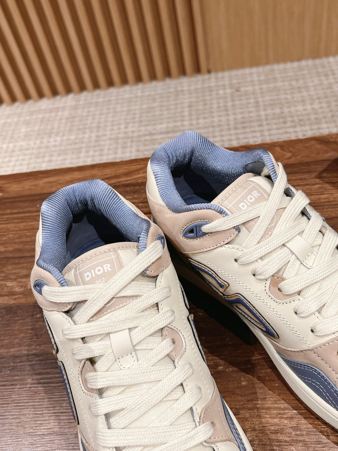 Dior unisex sneakers, pair view with Dior tongue tags and blue collar lining.