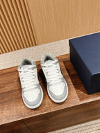 White and gray low-top sneakers with white laces and leather-look panels