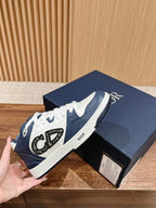 Low-top sneakers in white and navy with Dior logo on the side strap