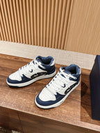 Unisex low-top sneakers with white uppers, navy overlays, and white laces