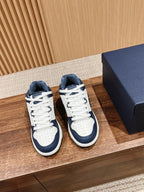 Unisex low-top sneakers with white leather and navy panels, white laces