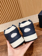 Pair of navy low-top sneakers with white midsoles and rear logo patch