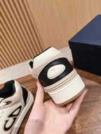 Cream unisex sneaker heel with black panel, contrast stitching, and logo detail