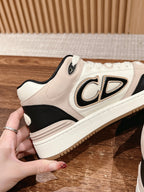 Cream and black unisex sneaker with lace-up front and side logo patch