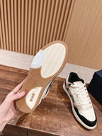 Unisex sneakers with cream soles; lace-up front and black accent side panels