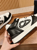 Dior unisex high-contrast sneakers with black leather panels, white overlays, and laces