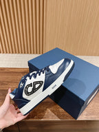 Navy and white low-top sneakers with large side graphic and Dior branding