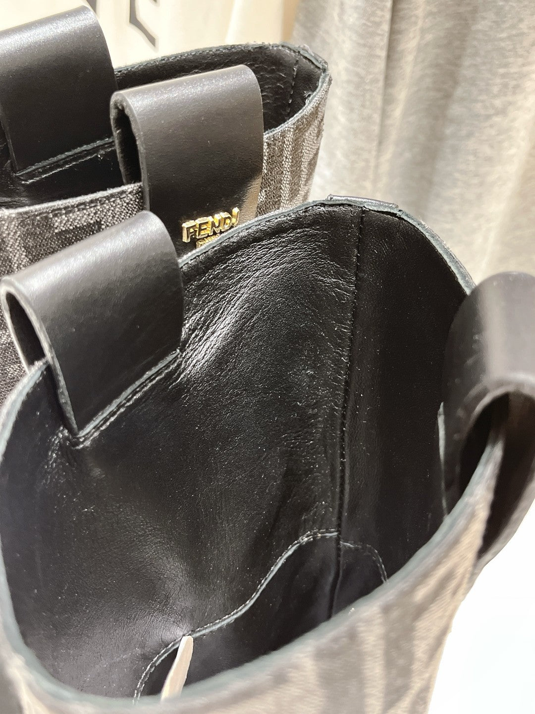 Fendi boot shaft close-up with black leather upper and FF pattern paneling