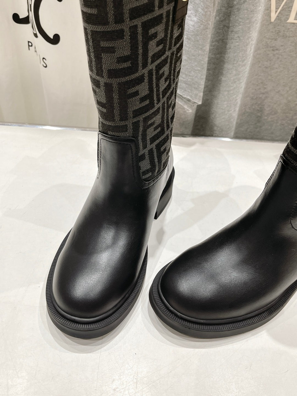 Black Fendi ladies boots, close toe-to-shaft view with FF monogram side panel