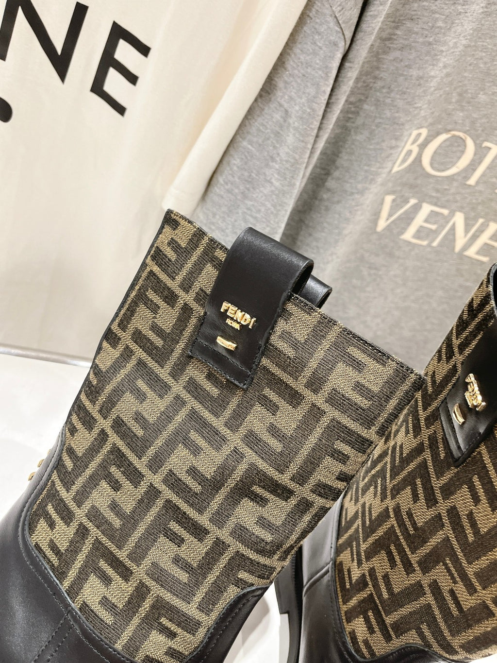 Fendi FF-logo boots, black ankle panel with gold-tone stud buckle detail.