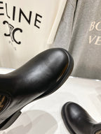 Fendi black leather boot with ribbed elastic cuff and textured outsole.