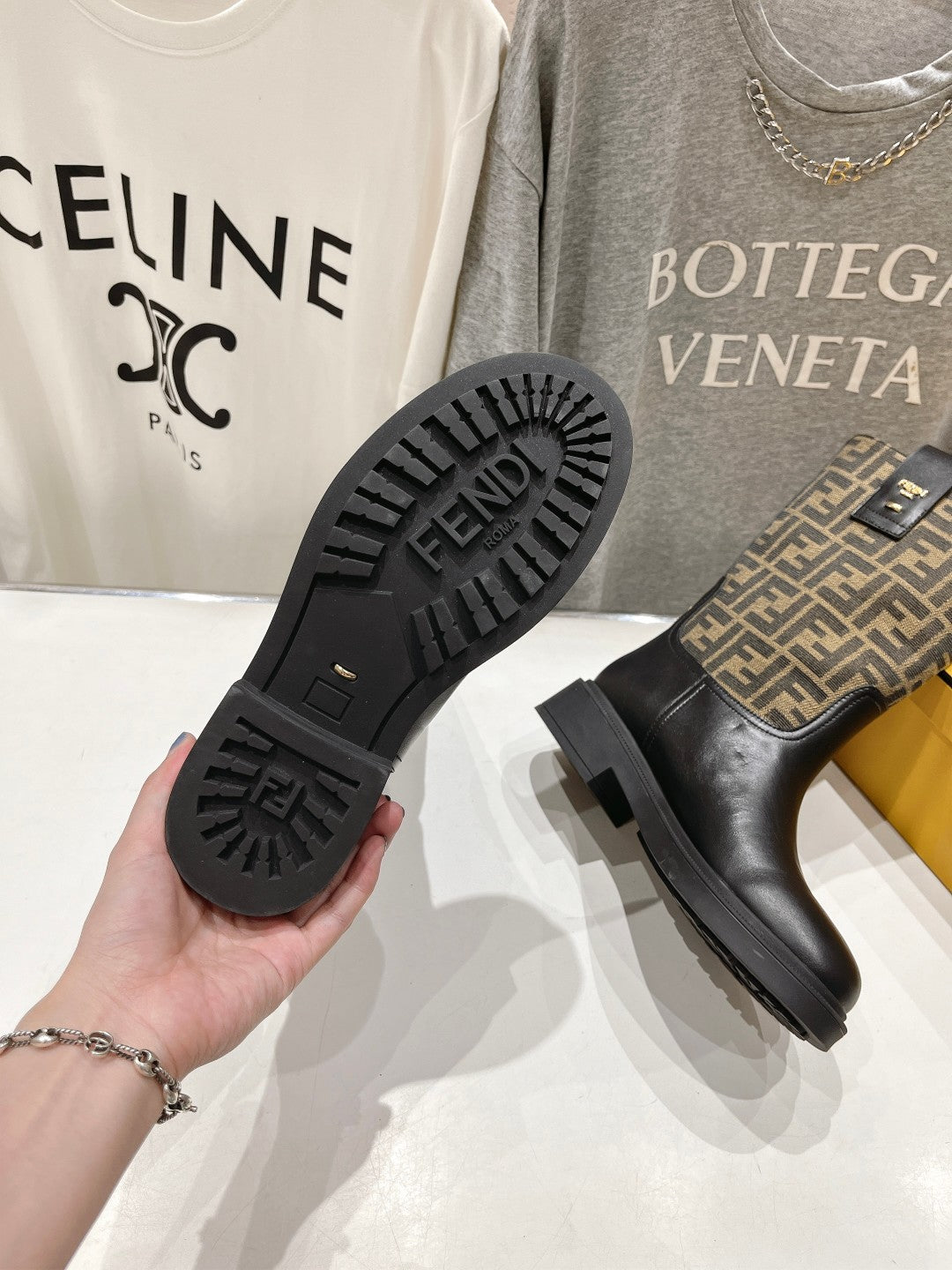 Fendi boots outsole showing FF FENDI tread and black rubber sole.