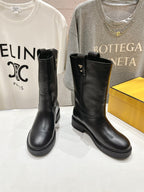 Fendi women’s leather boots, black, side view with pull tab and stitched detailing.