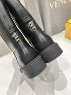 Fendi women’s leather boots, black, close-up of side panel with metal eyelets.