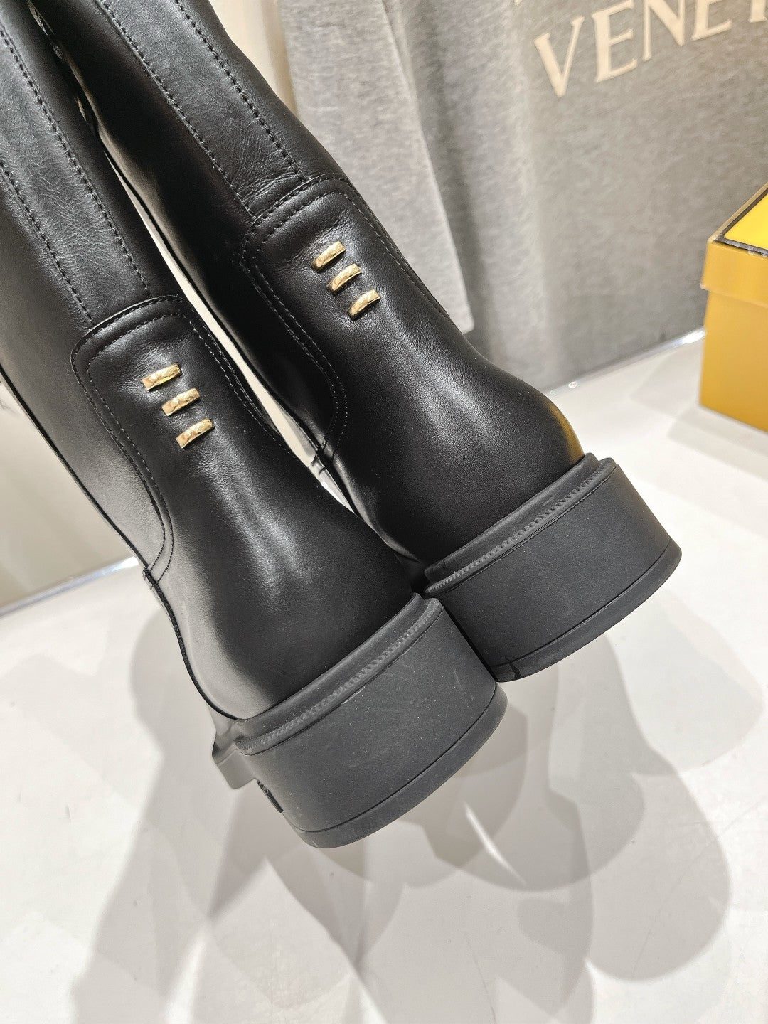 Fendi women’s leather boots, black, close-up of side panel with metal eyelets.
