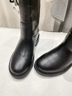 Fendi women’s leather boots, black, close-up of lower shafts and round toe.