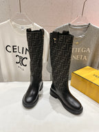 Fendi monogram tall leather boots in black, shown side by side on display