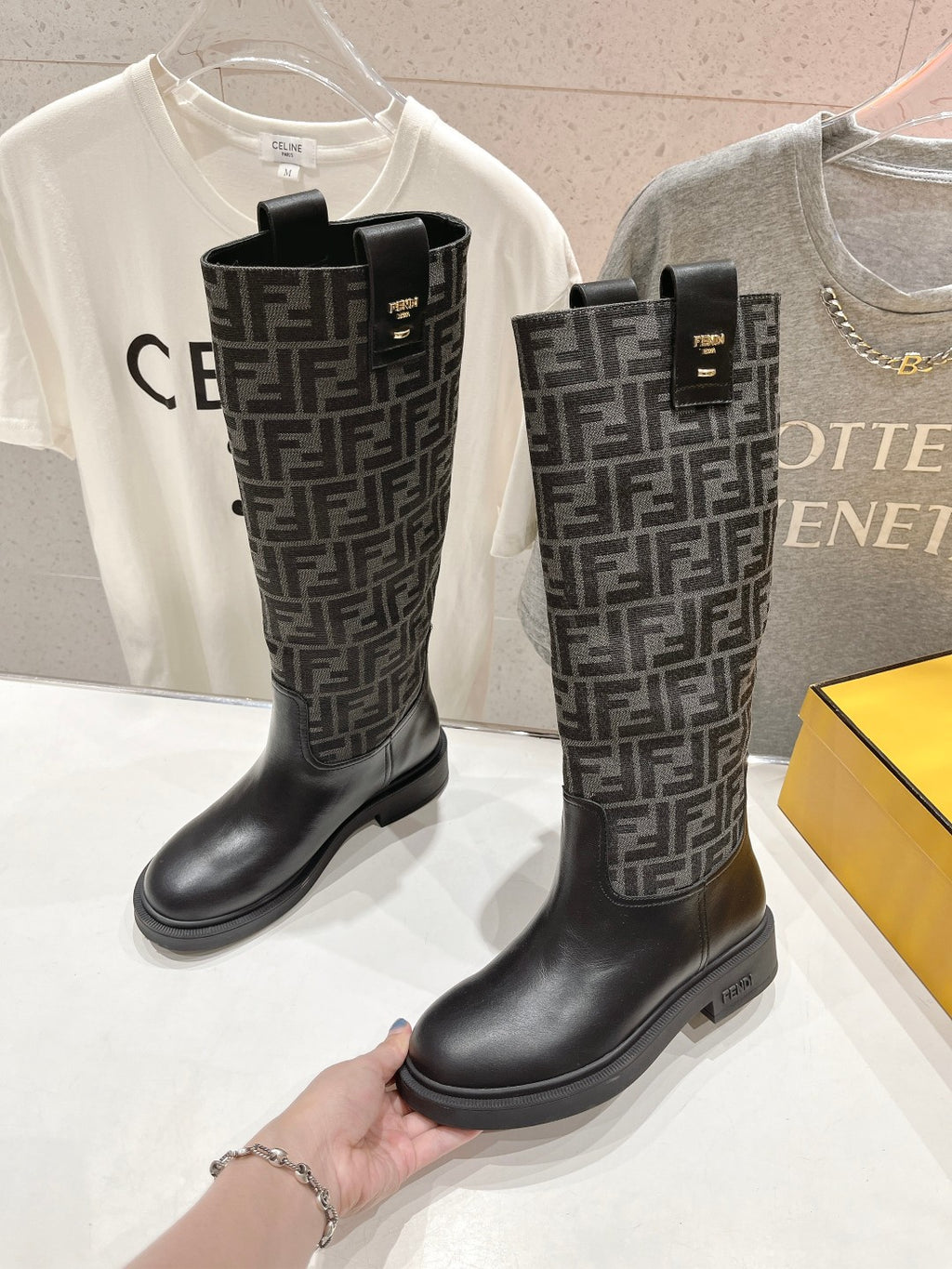 Fendi tall leather boots with dark logo pattern, black chunky sole