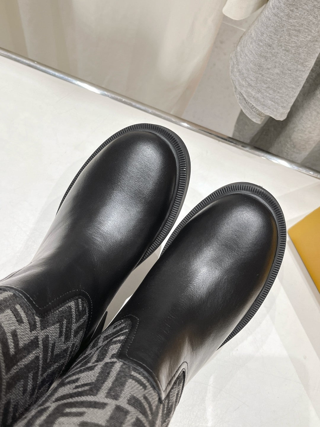 Fendi logo leather boots toe and upper close-up, smooth black finish