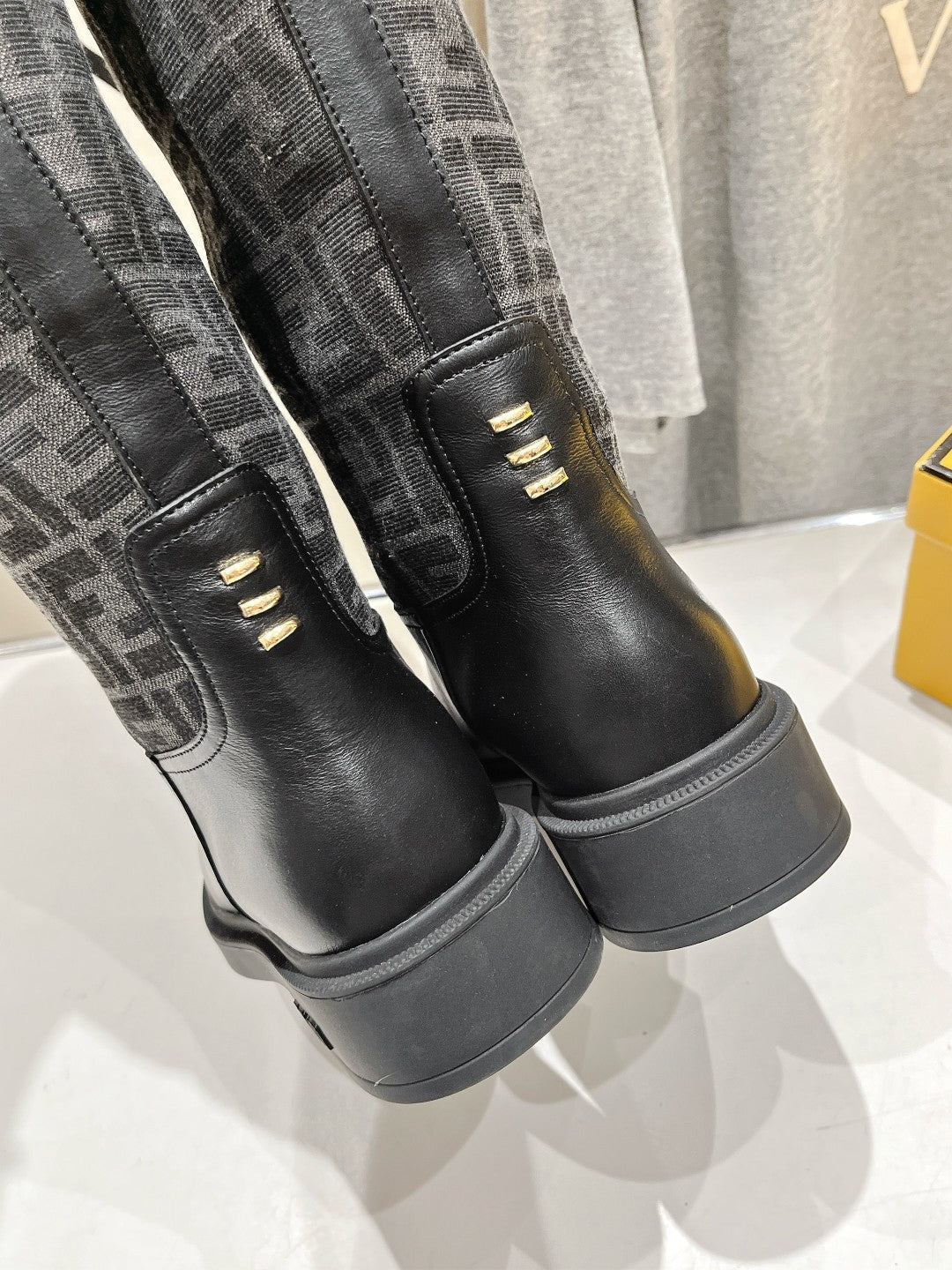 Fendi logo boots heel close-up, black leather with contrast monogram panels