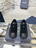 Black lace-up sneakers with Dior logo branding on tongue and sides, on box