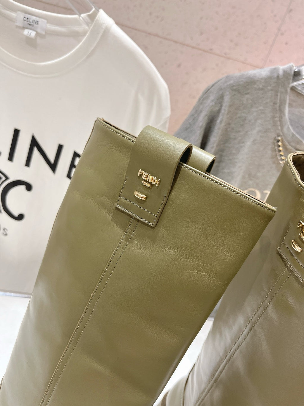 Olive green boot upper with pull-on tab and Fendi logo patch.