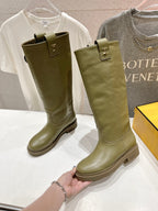 Olive green knee-high boots with square toe and pull-on strap, held by hand.