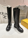 Black knee-high leather boots with side pull tabs and low stacked heel